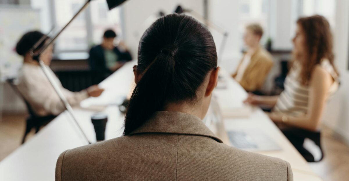 Diverse professionals collaborating in a modern office space focused on teamwork and project management