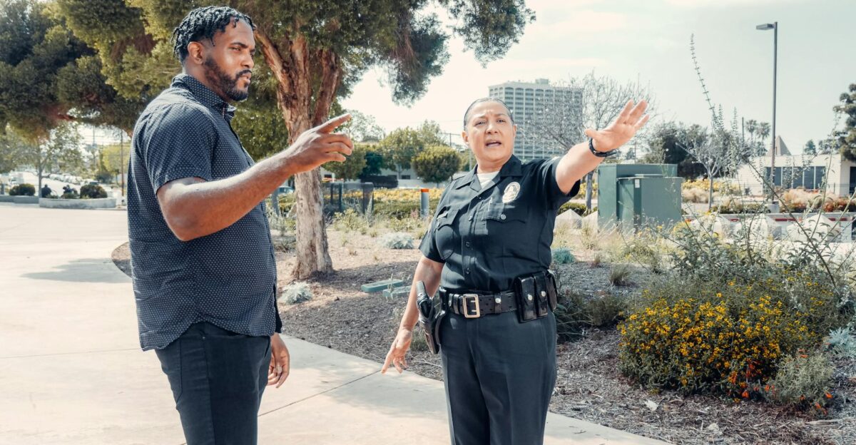 Police officer speaking with a man outdoors showcasing community engagement