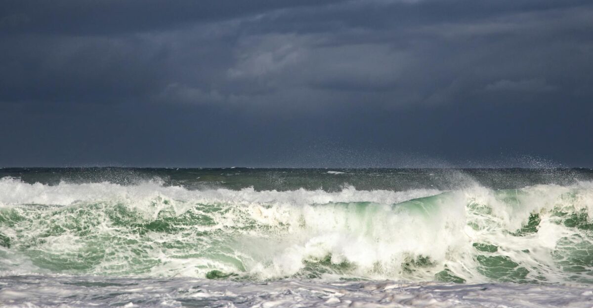 Capture of powerful ocean waves crashing under a dark and moody sky