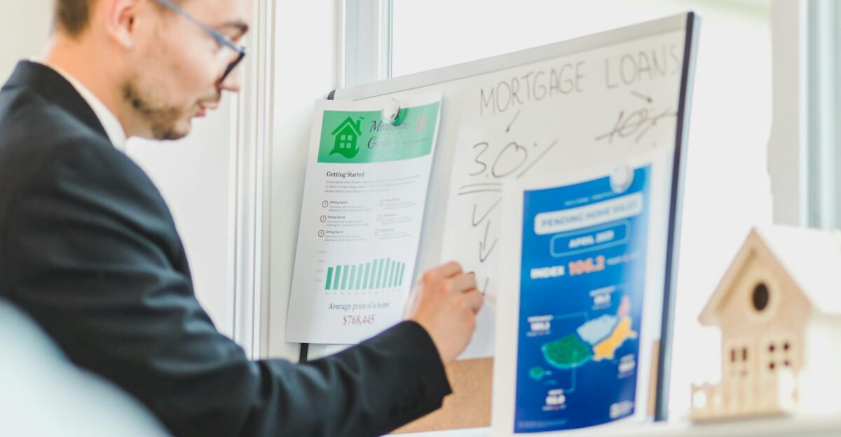 Real estate agent analyzing mortgage loan details on a whiteboard in an office setting