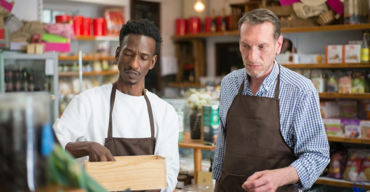 Two male employees organizing products in a cozy grocery store