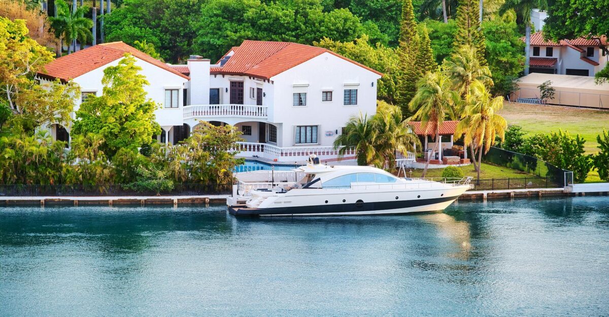 Elegant Miami luxury villa by the waterfront with a yacht docked nearby unique architecture and tropical setting