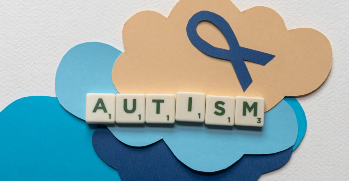 Creative representation of autism awareness using scrabble tiles on colorful clouds and ribbon.