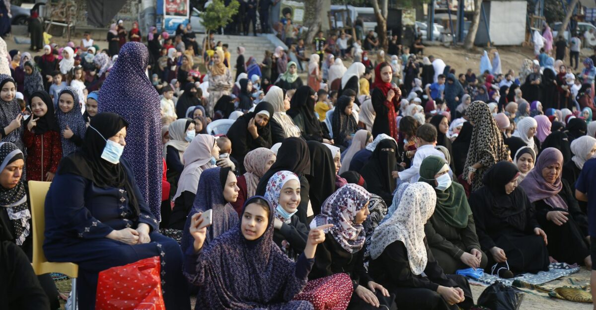 Vibrant crowd celebrating Eid prayers outdoors in Gaza City showcasing Palestinian traditions