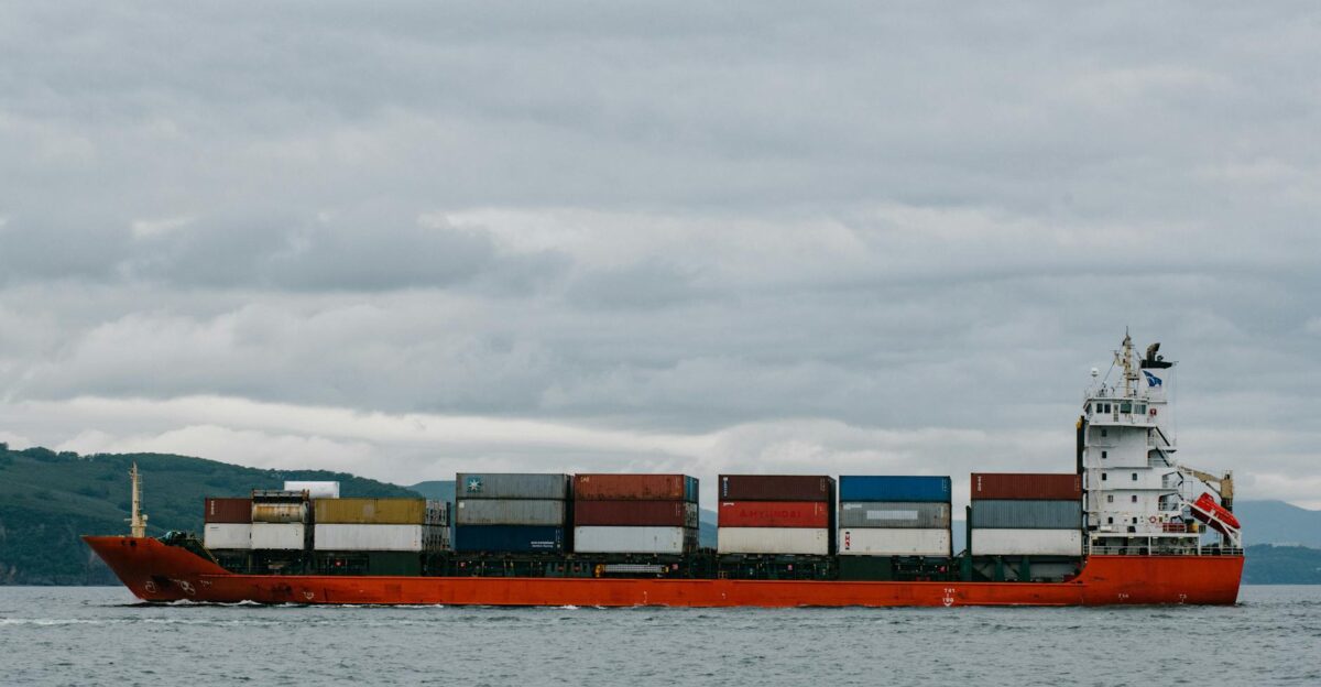 Container ship navigating the waters of Kamchatka Russia against a cloudy sky