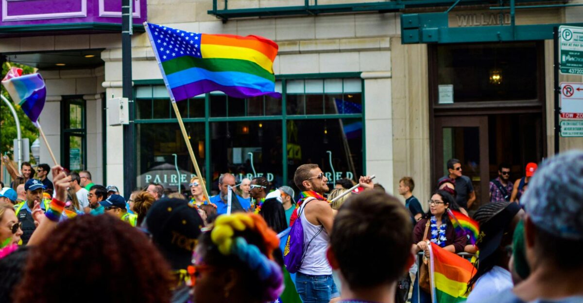 Vibrant Pride parade on a Chicago street with diverse attendees and rainbow flags waving