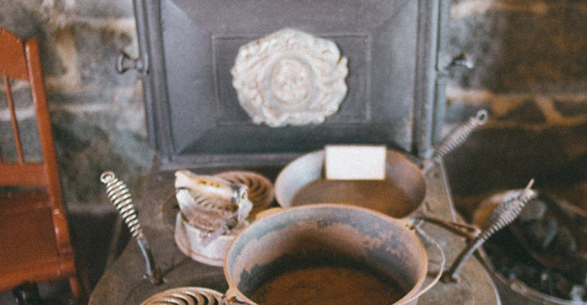 Antique cast iron stove with rustic cookware in a cozy setting