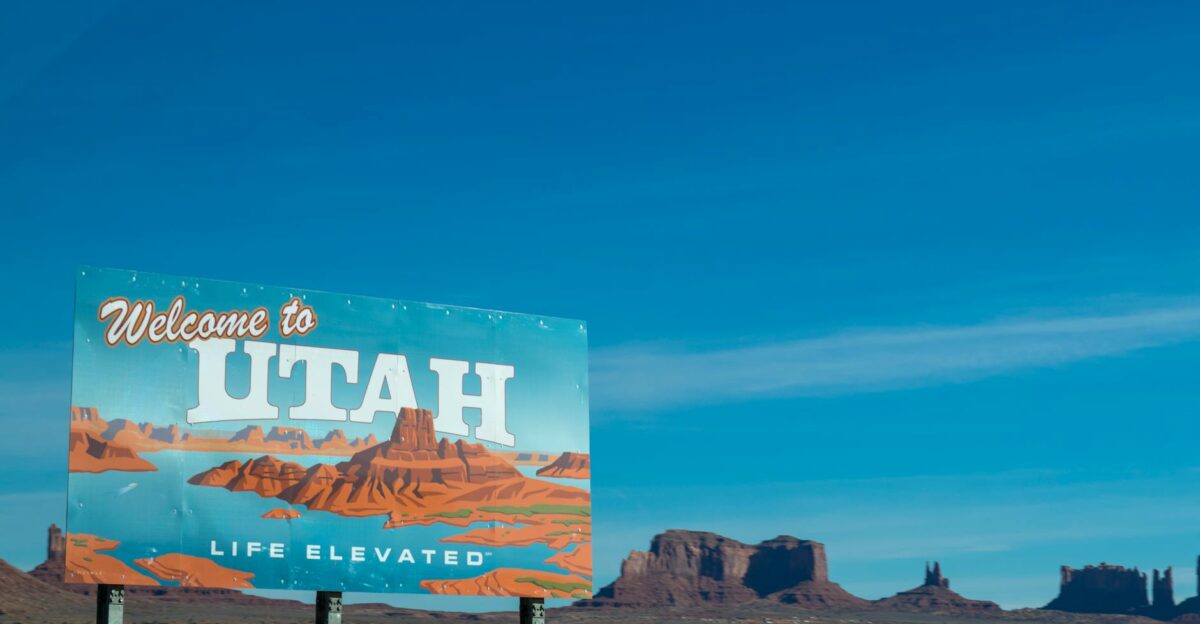 Scenic view of Utah welcome sign against desert and blue sky backdrop