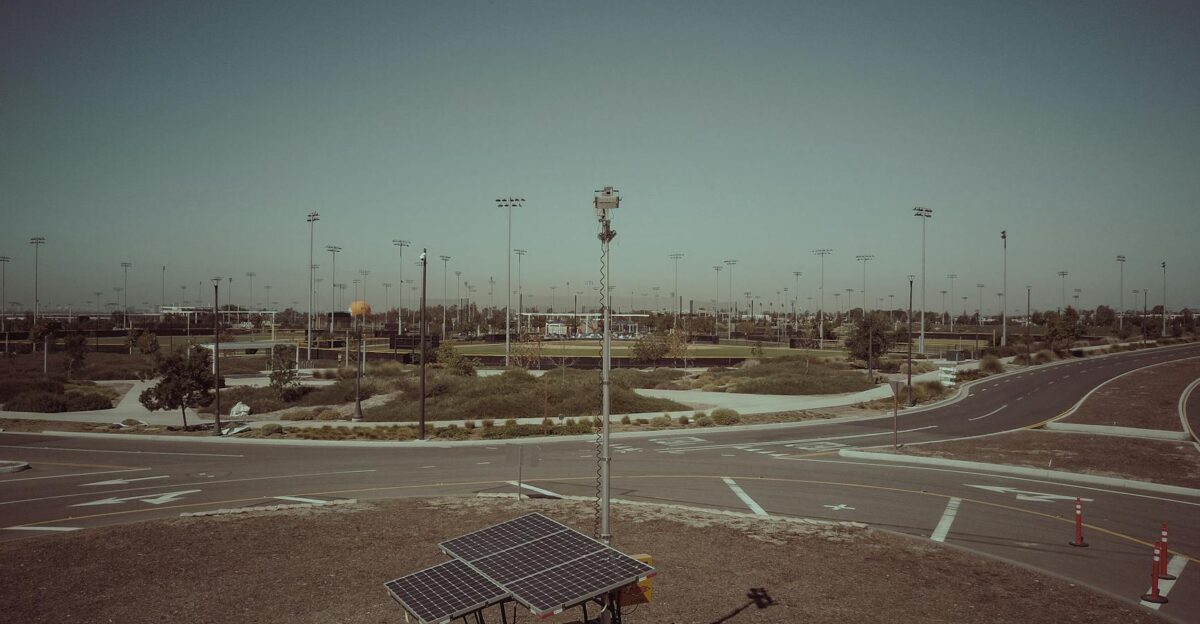 A mobile solar power unit in an open field area captures clean energy