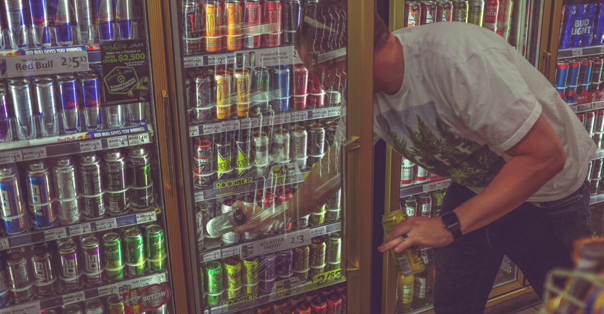man getting can in beverage cooler