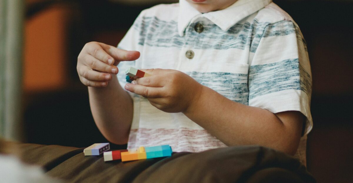 boy holding block toy