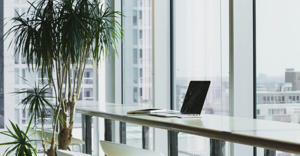turned off laptop computer on top of brown wooden table