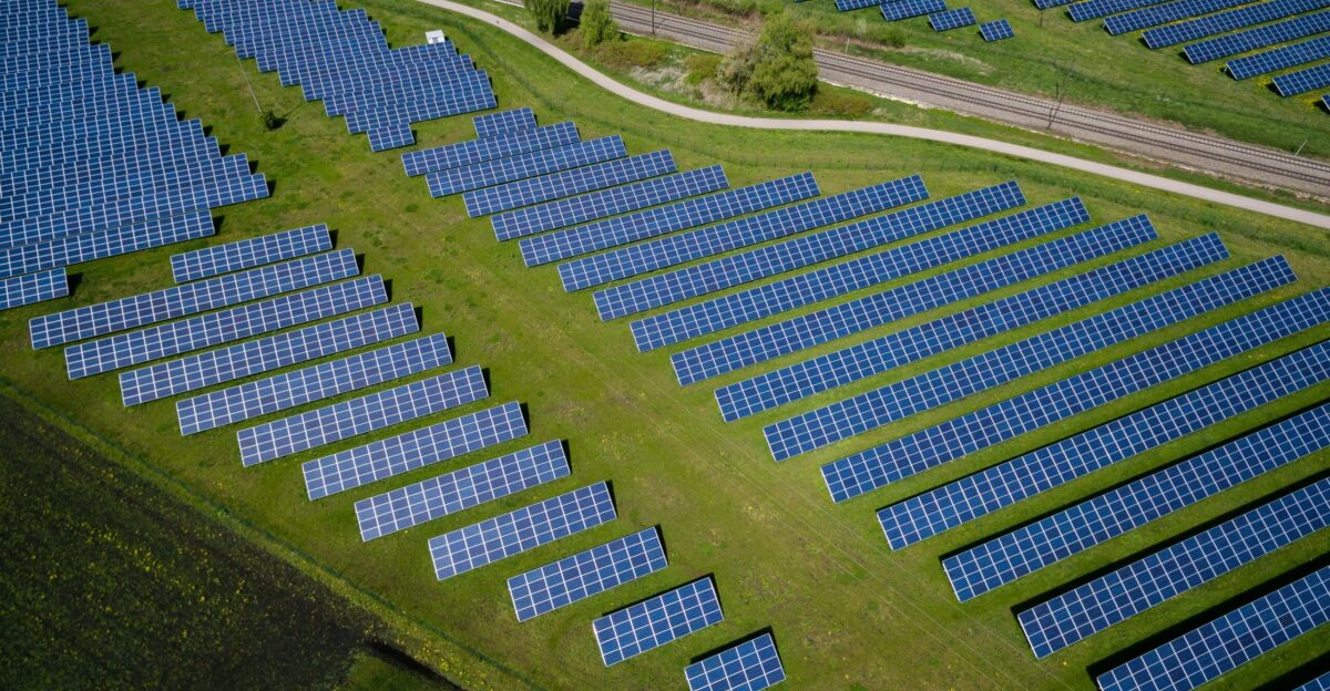 aerial photography of grass field with blue solar panels