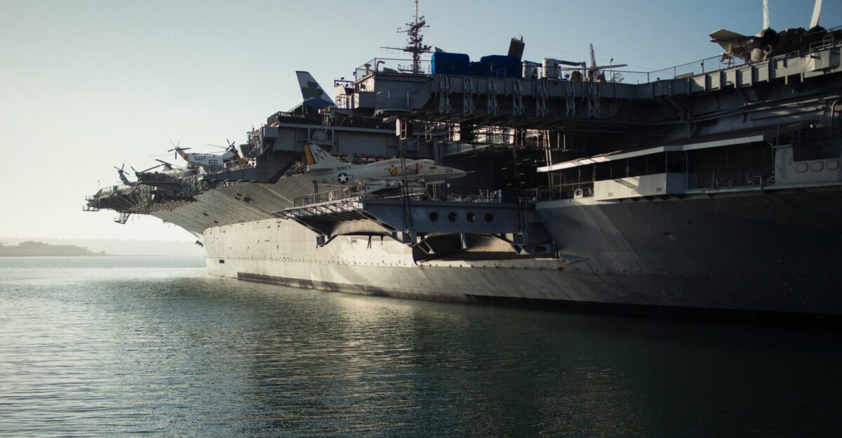 gray warship on body of water