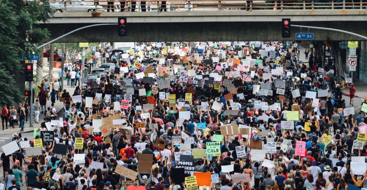 a large group of people holding up signs