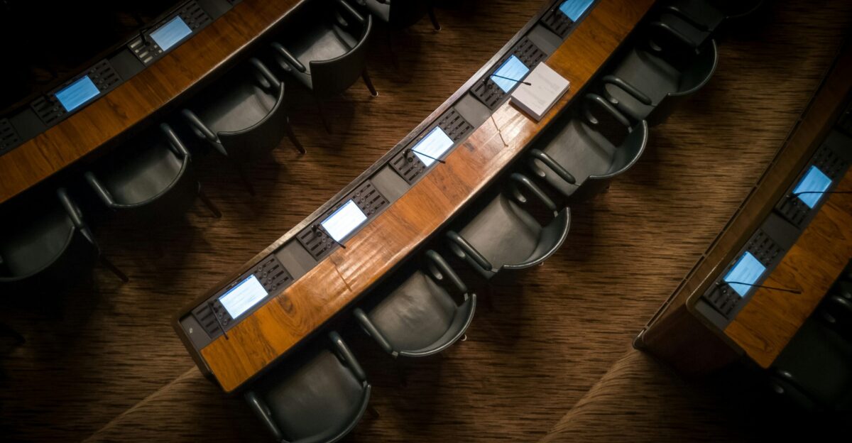 low light photography of armchairs in front of desk