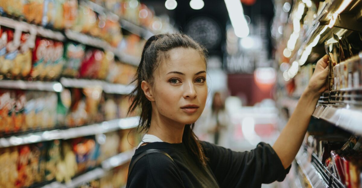 woman selecting packed food on gondola