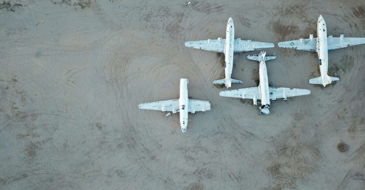 three white airplanes on grey surface
