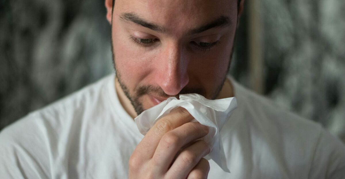 man wiping mouse with tissue paper