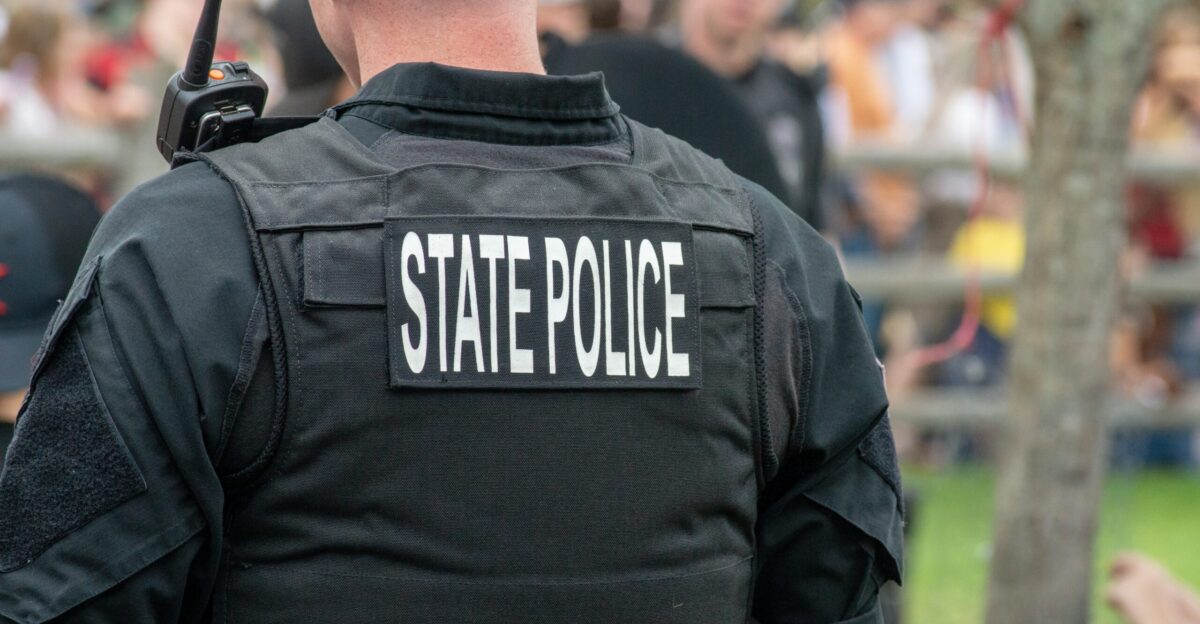 person wearing black State Police vest