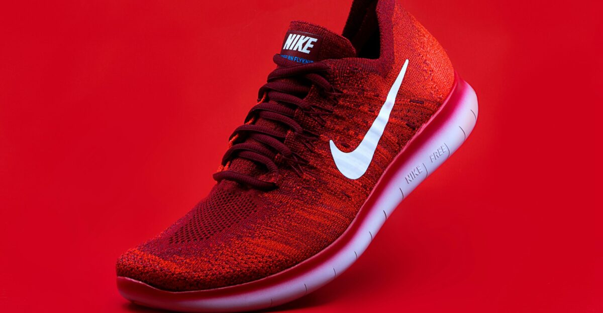unpaired red Nike sneaker