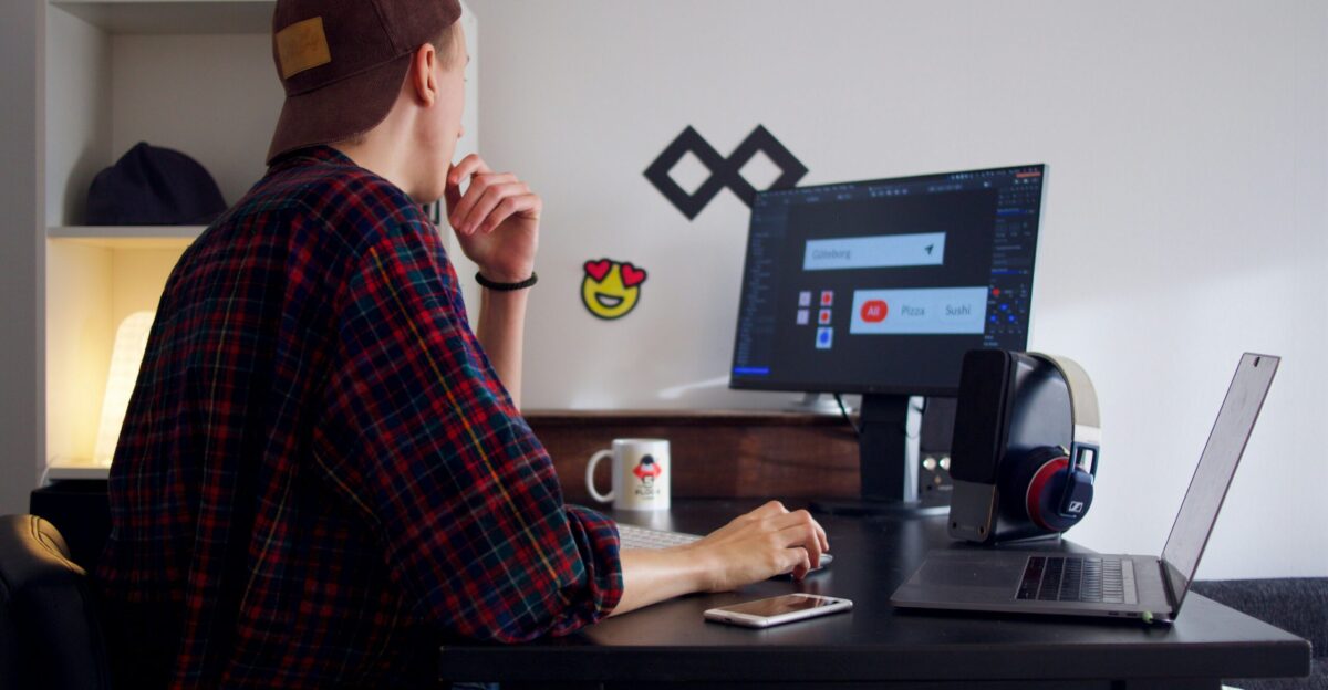 man sitting near table using computer