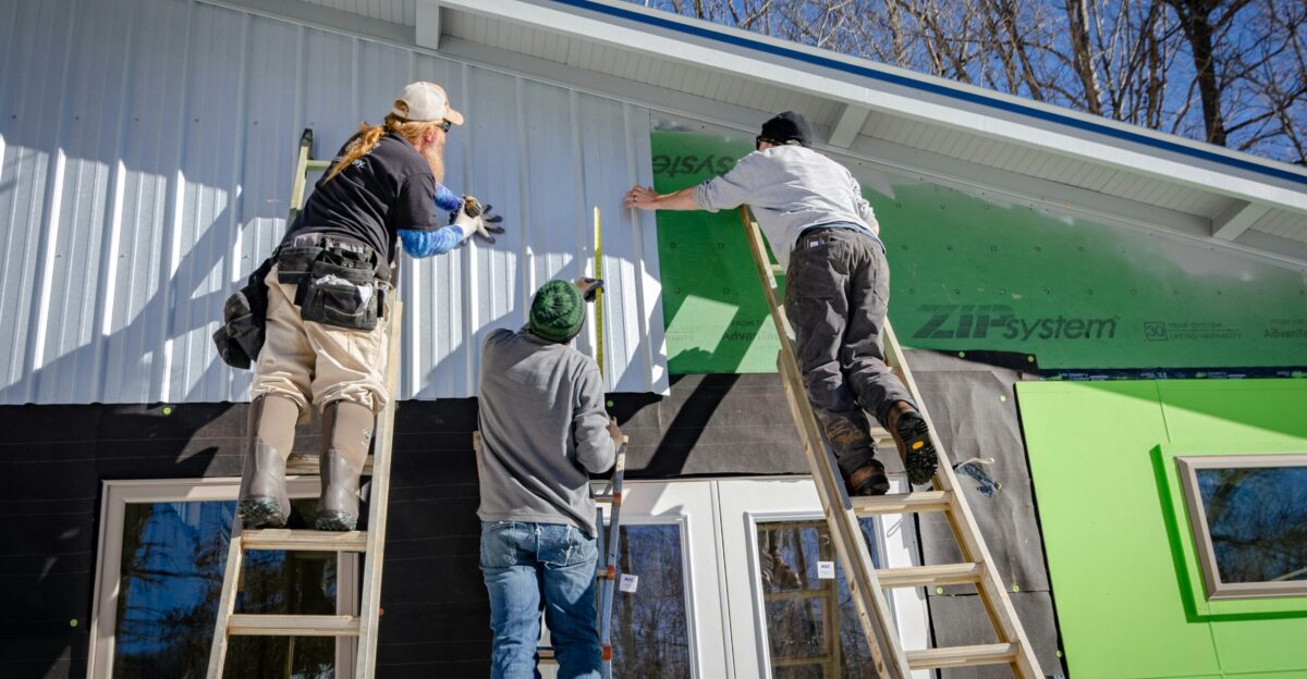 three person climbing on ladder