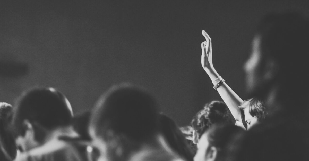 person raising right hand