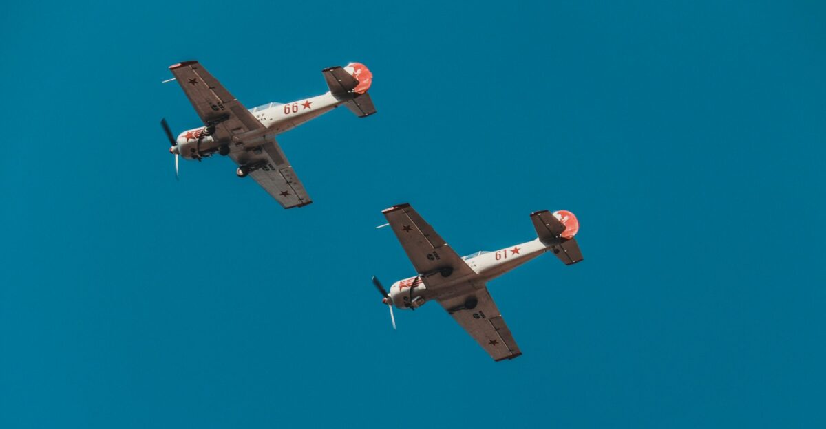 white and orange biplanes