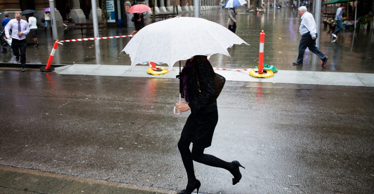 woman carrying white umbrella