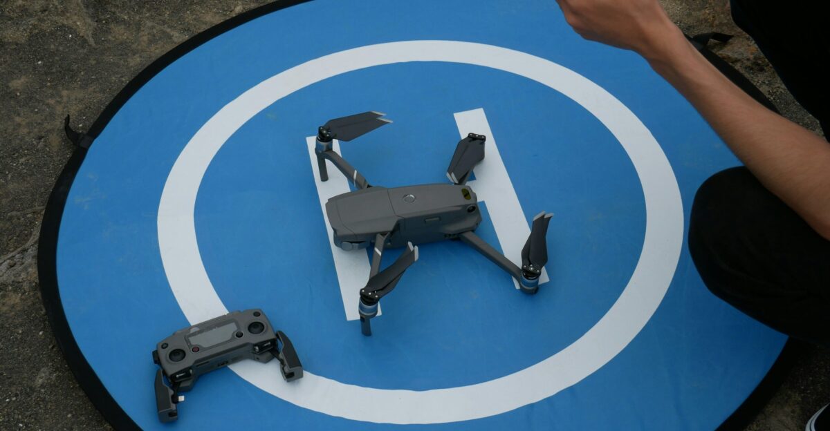 black quadcopter drone beside controller