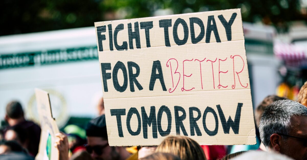person holding fight today for a better tomorrow sign