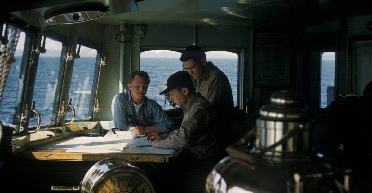 three men inside ships cabin