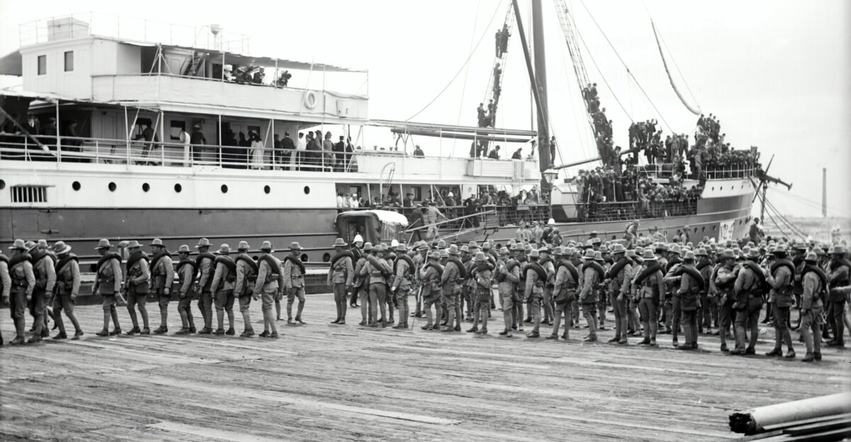 group of boy s standing near on ship