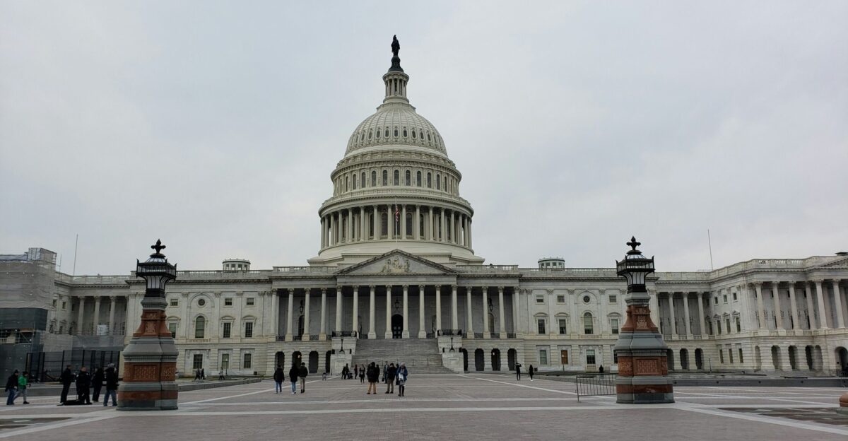 people walking on street near white concrete building during daytime