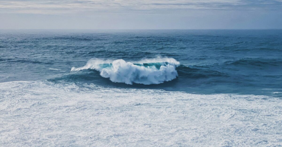 white sea waves on white sand during daytime