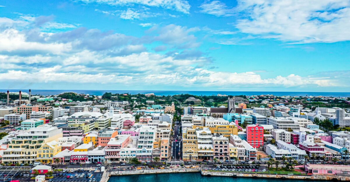 city buildings near body of water under blue sky during daytime