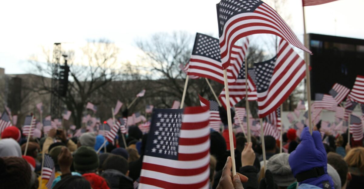 people holding us a flag during daytime