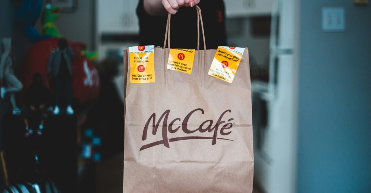 person holding white and brown paper bag
