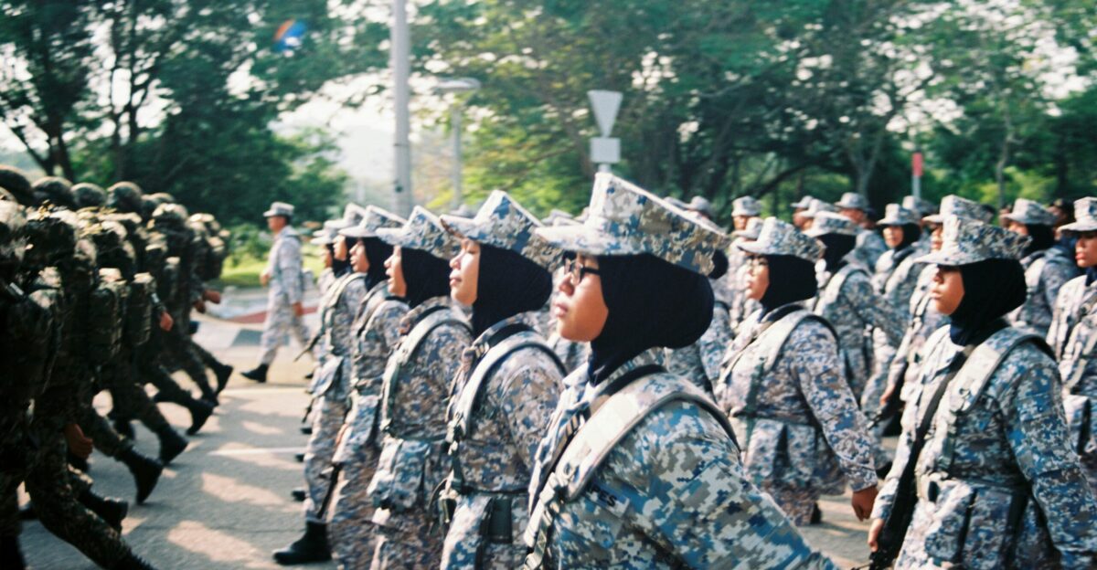 soldiers in black and white uniform standing on gray concrete road during daytime