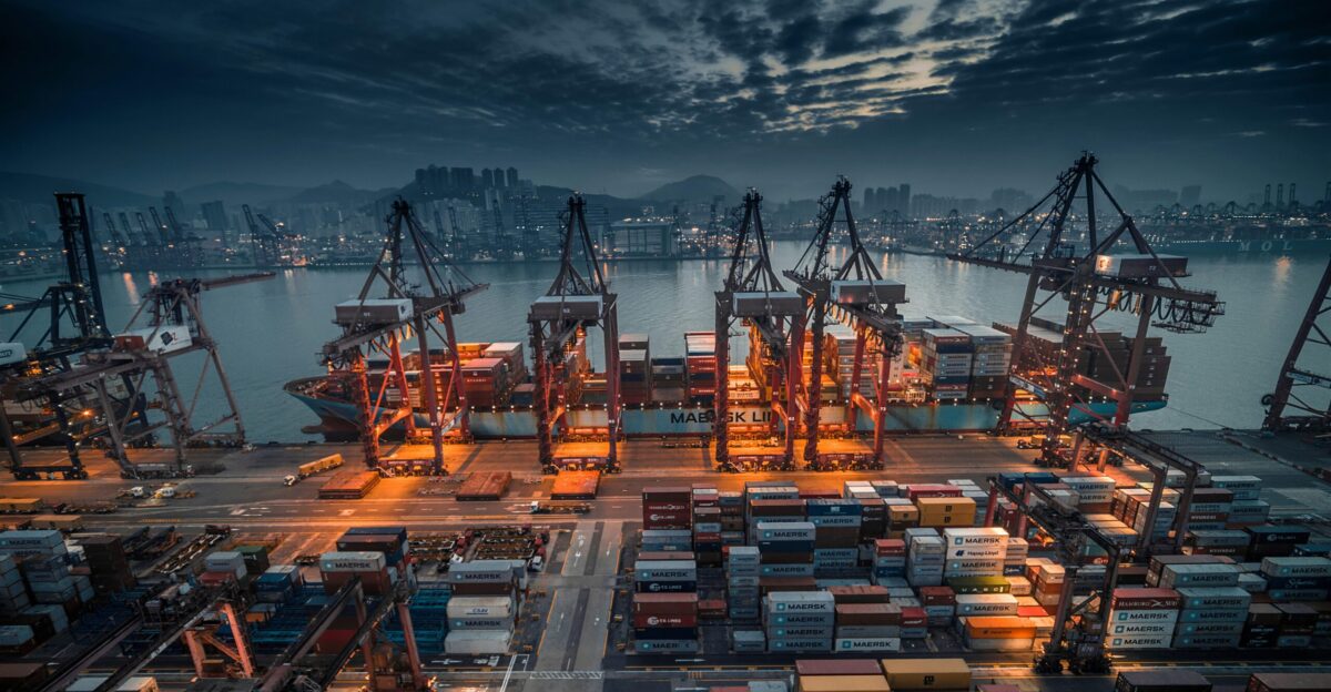 red and black cargo ship on dock during daytime