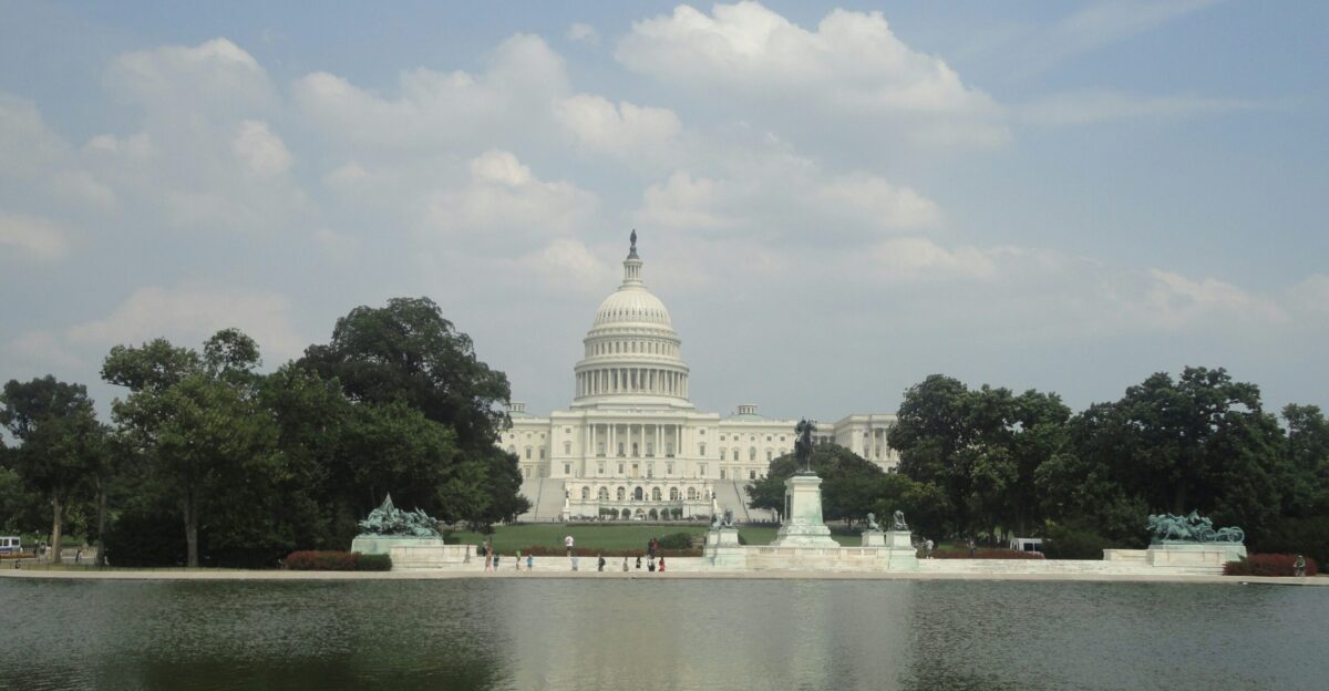 white dome building near green trees under white clouds during daytime