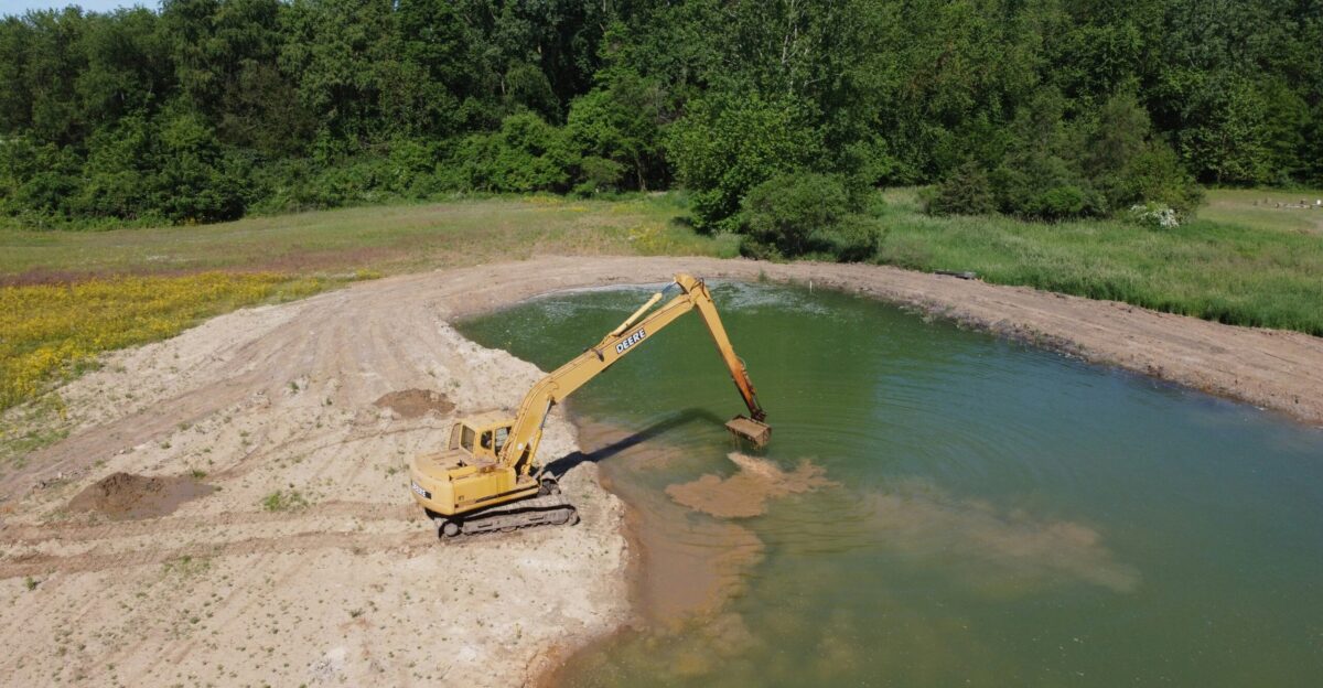 yellow crane near body of water during daytime