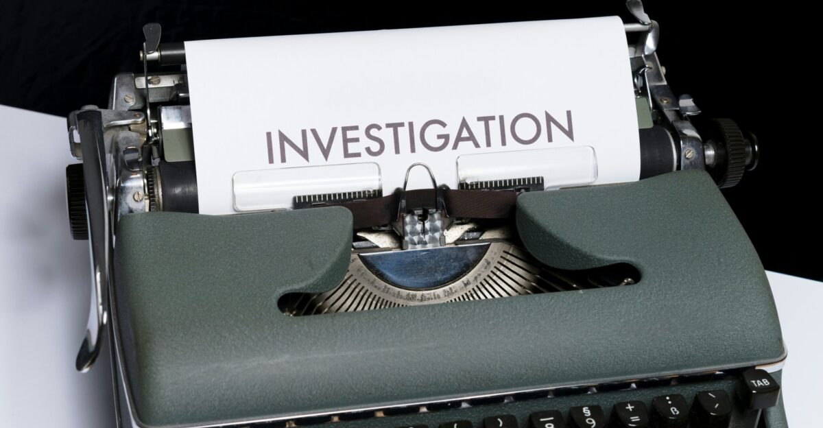 green and white typewriter on blue textile