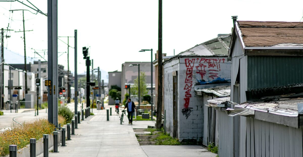 gray concrete road with cars parked beside