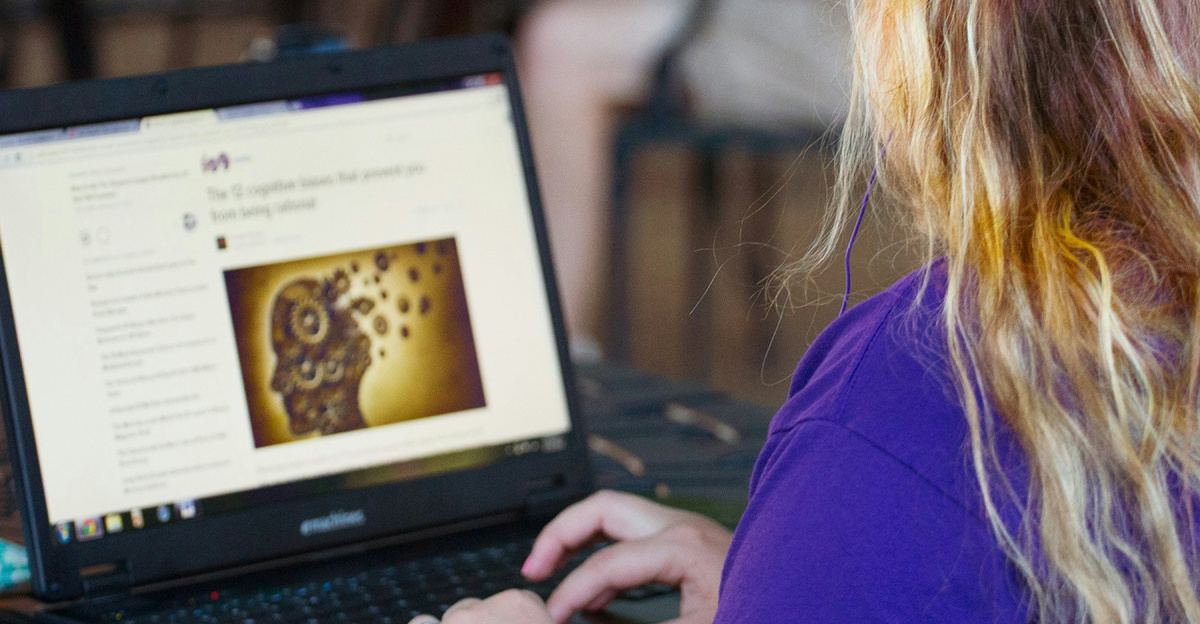 woman in purple shirt using black laptop computer