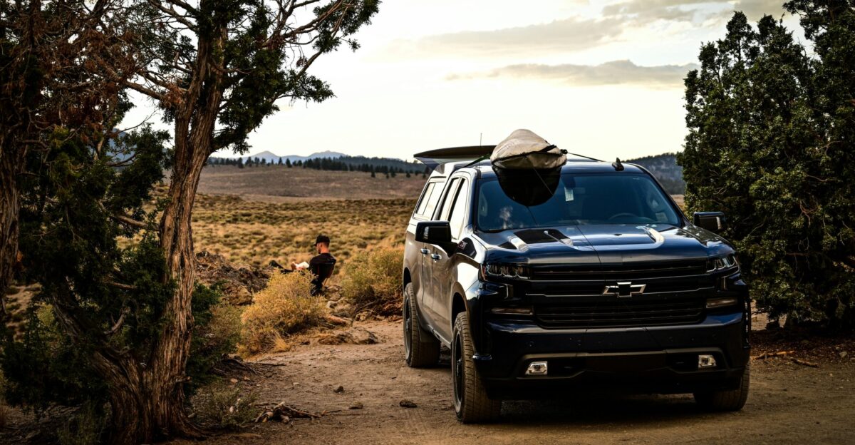 black suv on dirt road during daytime
