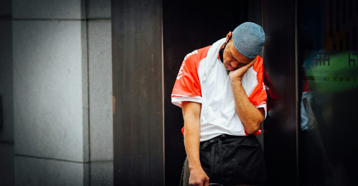 man in white t-shirt and black pants wearing white and black knit cap