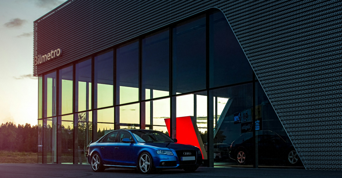 red car parked beside building
