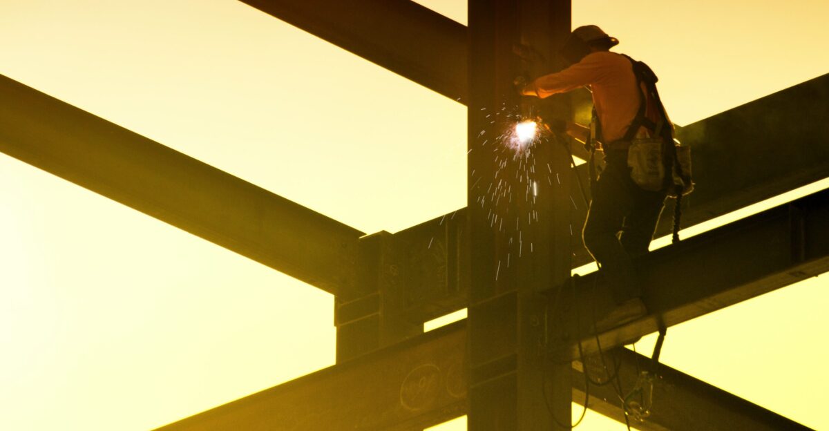 man in black jacket and black helmet standing on top of building during daytime